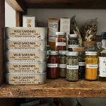 Cans of sardines on a pantry shelf